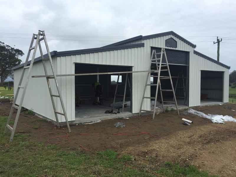 A White Barn Is Being Built With A Ladder In Front Of It – South Kempsey NSW - Fair Dinkum Builds Macleay Valley Sheds