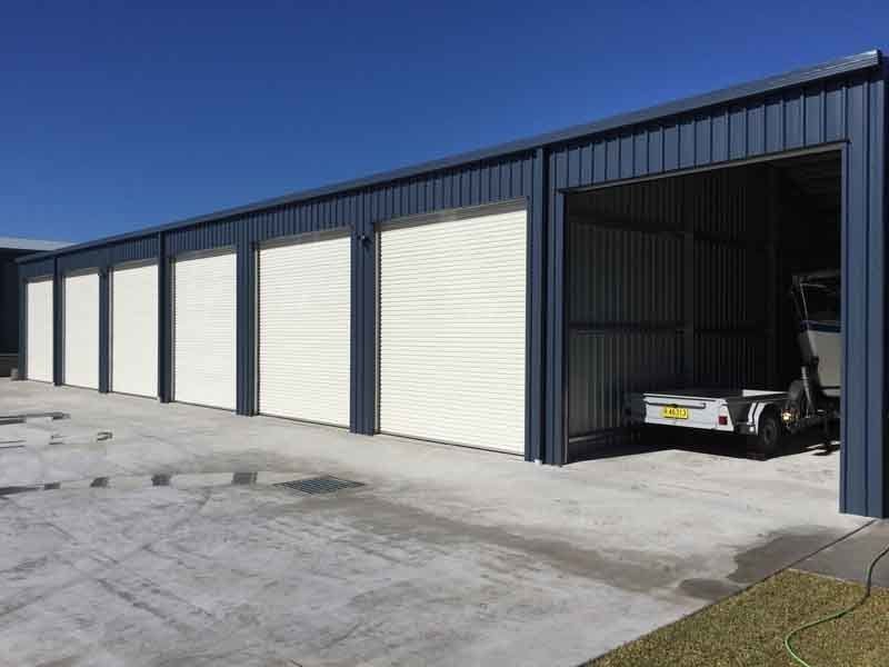 A Truck Is Parked In A Garage Next To A Row Of Garage Doors – South Kempsey NSW - Fair Dinkum Builds Macleay Valley Sheds