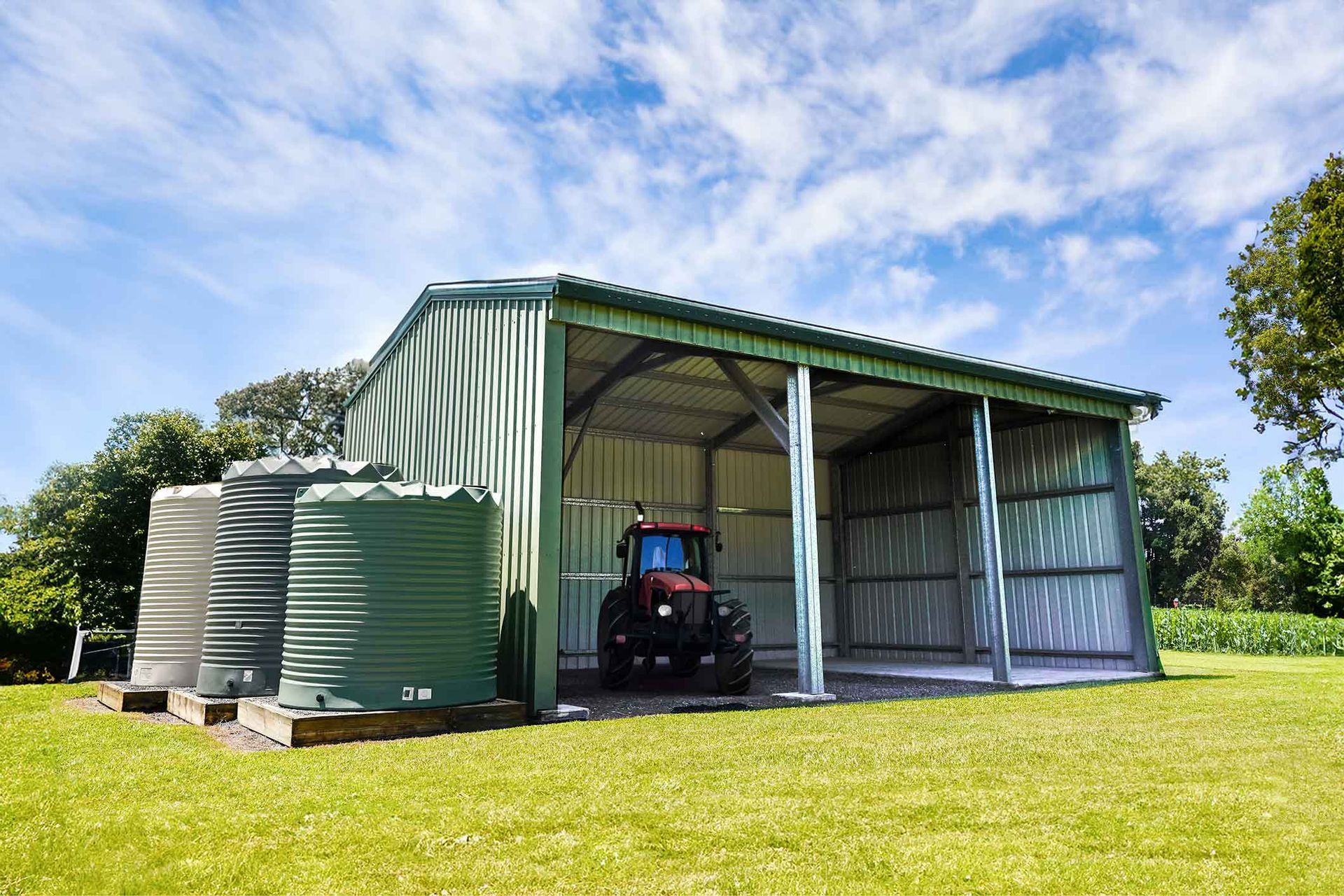A Tractor Is Parked In A Shed With Water Tanks – South Kempsey NSW - Fair Dinkum Builds Macleay Valley Sheds
