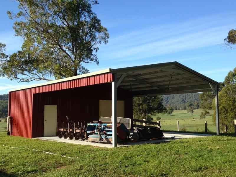 A Red Barn Is Sitting In The Middle Of A Grassy Field – South Kempsey NSW - Fair Dinkum Builds Macleay Valley Sheds