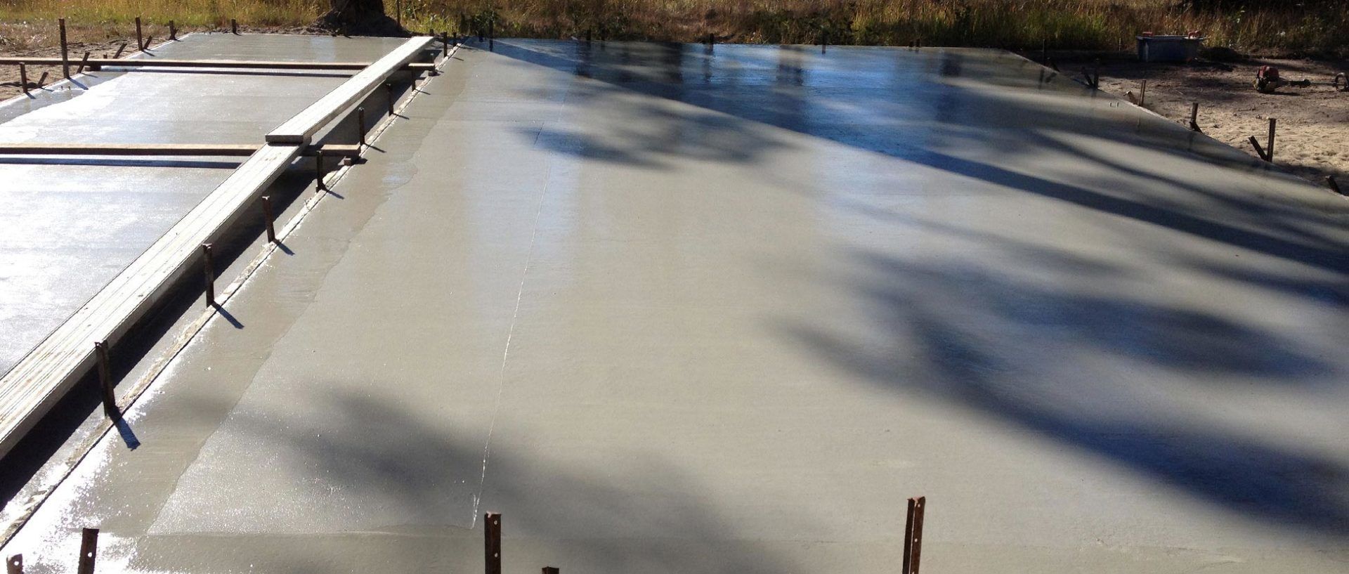A Close Up Of A Concrete Floor With A Shadow Of Trees On It – South Kempsey NSW - Fair Dinkum Builds Macleay Valley Sheds
