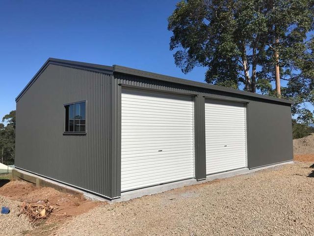 A Garage With Two White Garage Doors And A Window – South Kempsey NSW - Fair Dinkum Builds Macleay Valley Sheds