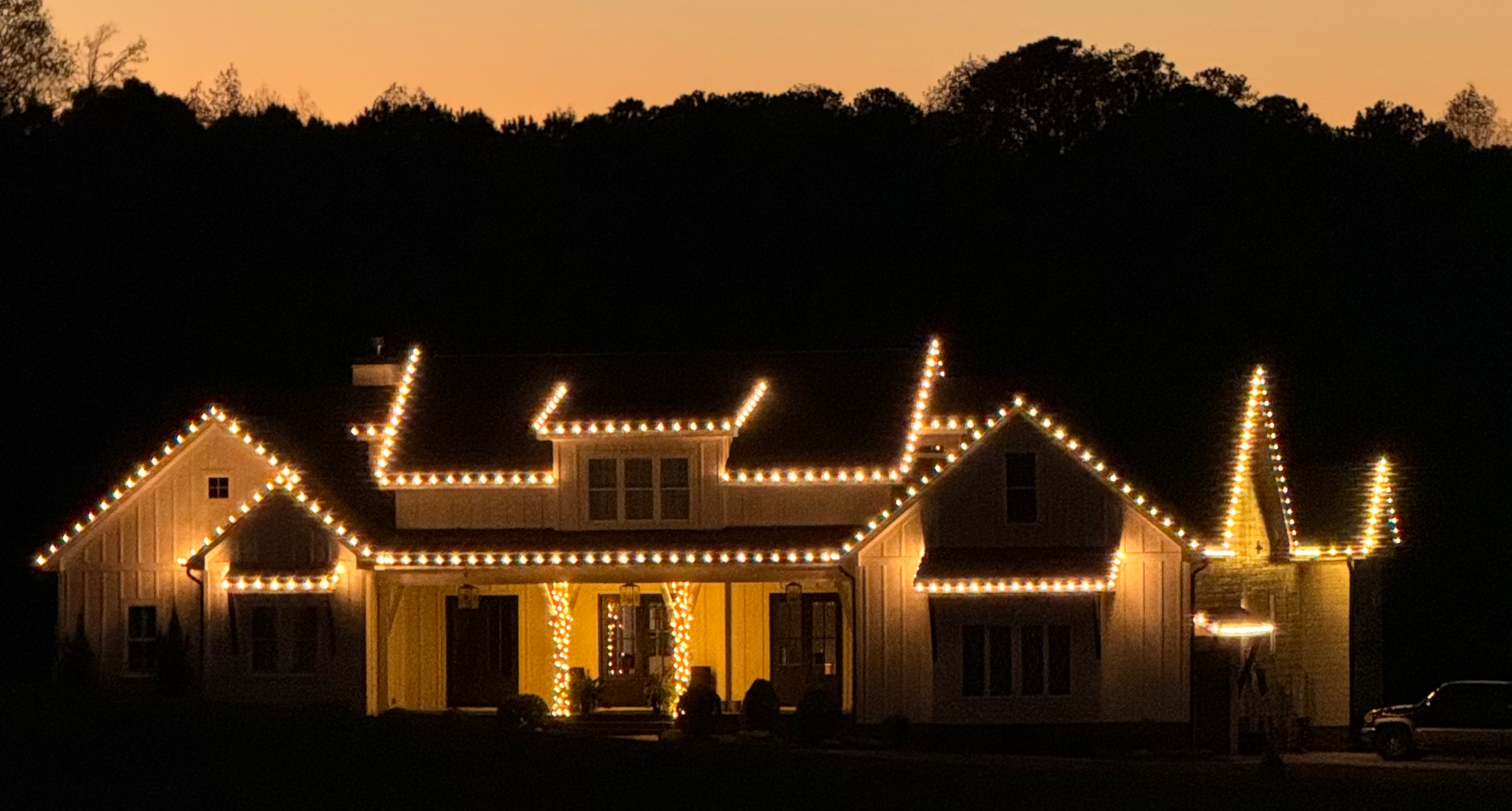 A house is lit up with christmas lights at night
