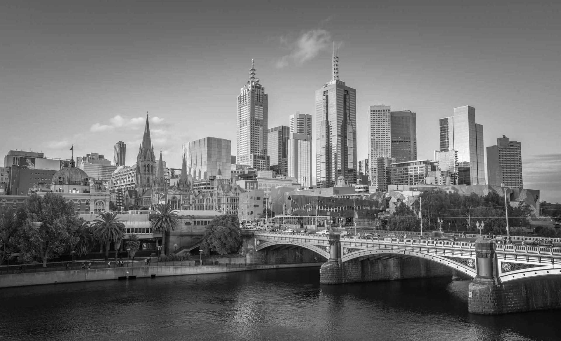 A black and white photo of a city skyline with lots of tall buildings.