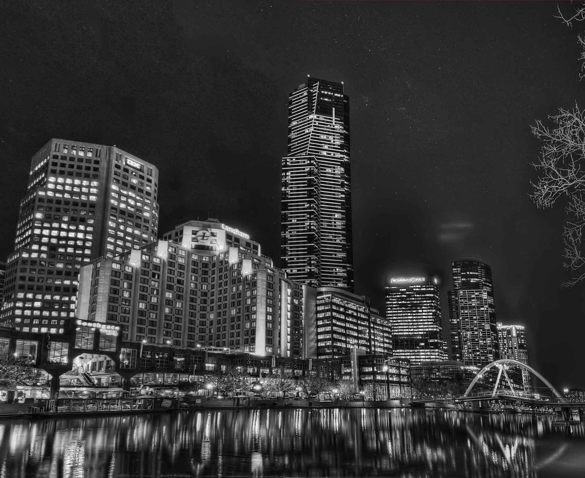 A black and white photo of a city skyline at night