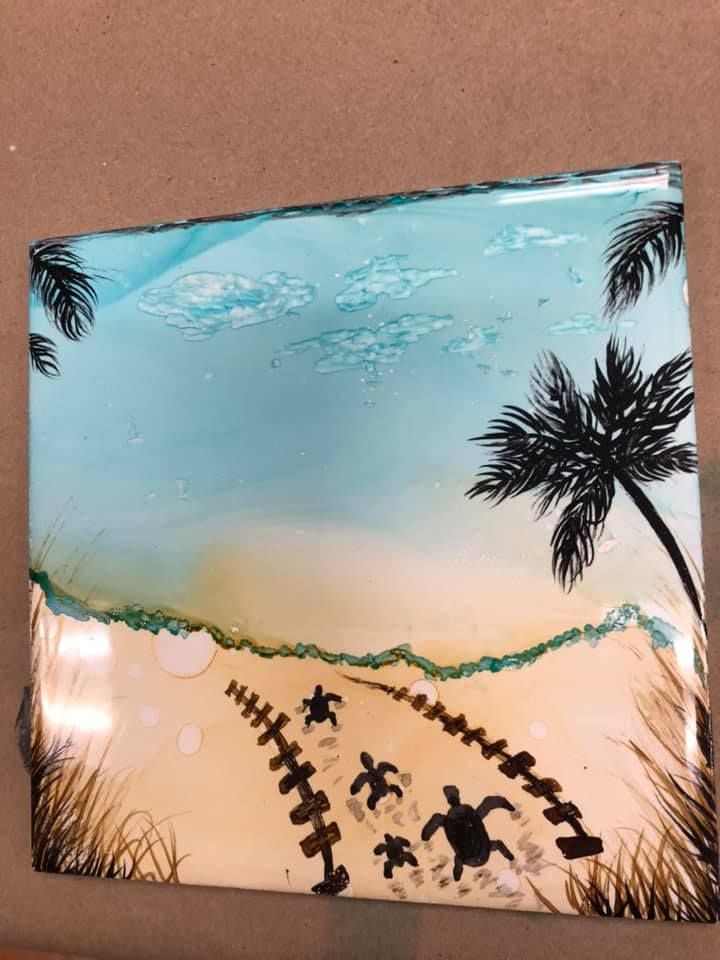 Coastal scene: sea turtles on sand, blue sky with palm trees, artwork in a USA shop.