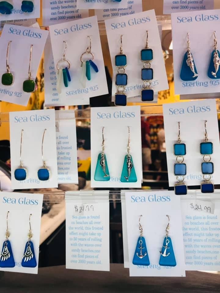 Sea glass earrings on display, various shapes and colors with 