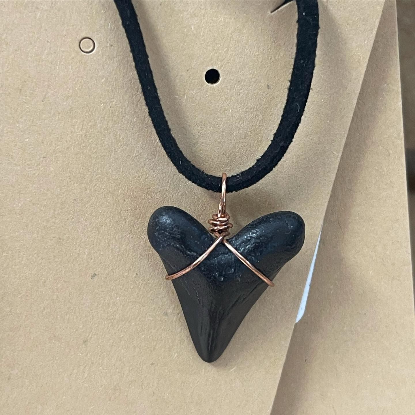 Black shark tooth pendant necklace with copper wire wrap, on black suede cord.