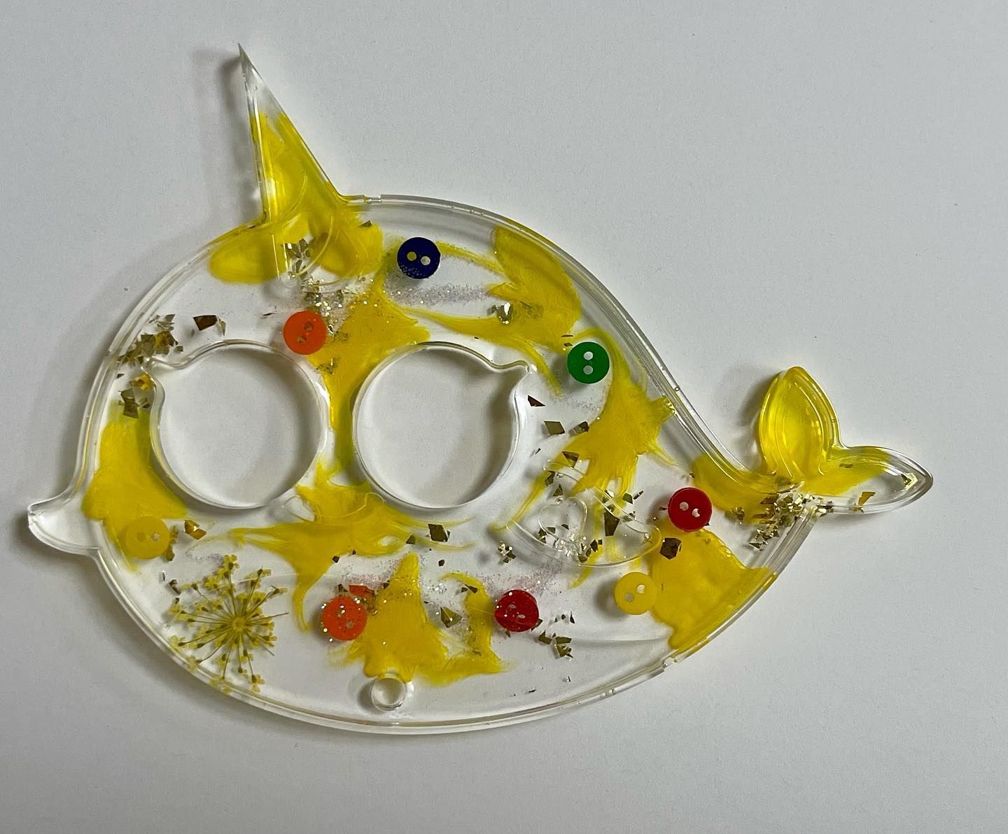 Narwhal-shaped resin tray with yellow accents, glitter, and colorful beads.