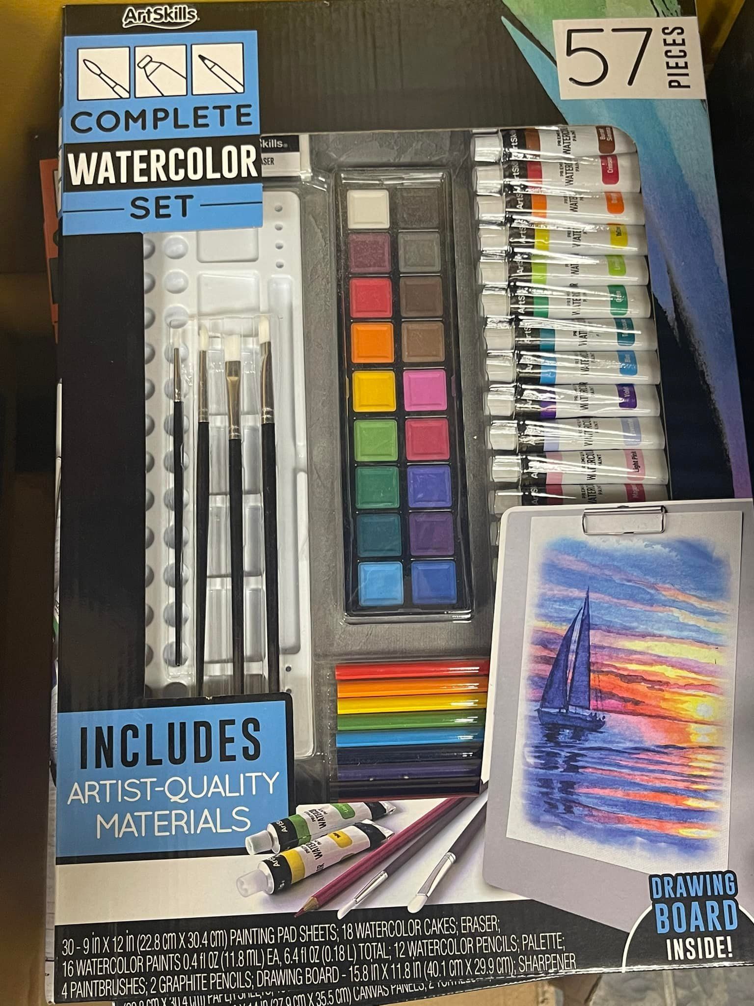 Watercolor painting set with paints, brushes, a palette, and a small painting board.