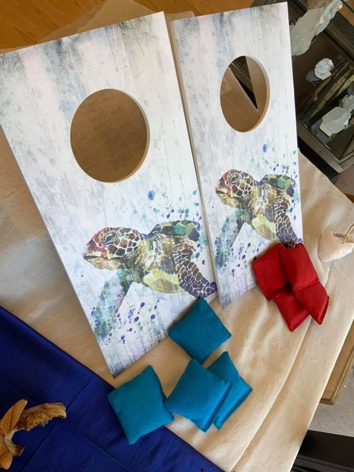 Cornhole game set with sea turtle design and bean bags in a USA shop.