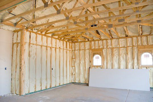 A room in a house under construction with a lot of insulation on the walls.