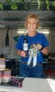 Women holding awards and a wine bottle