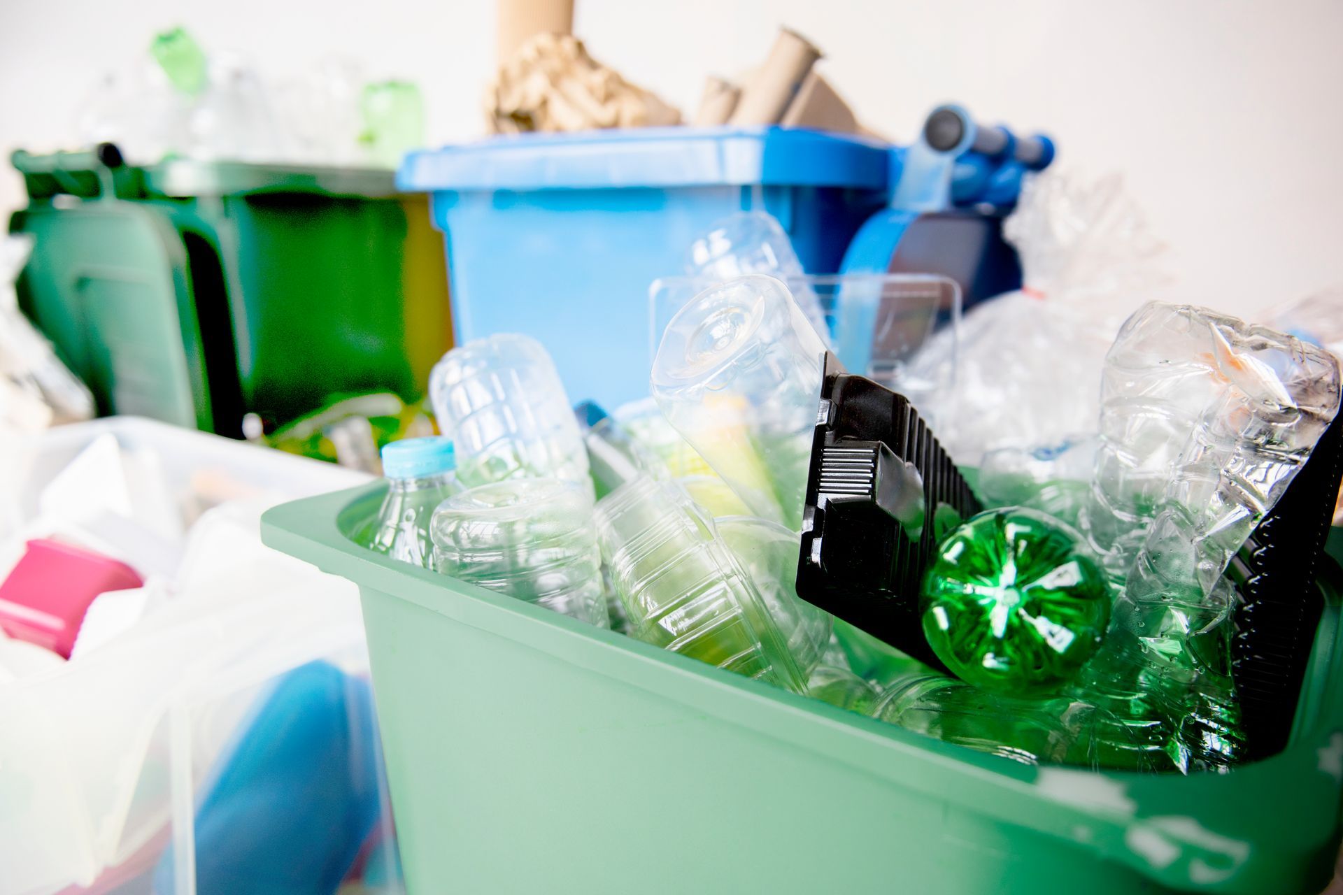 Recycling bins filled with plastic bottles and containers.