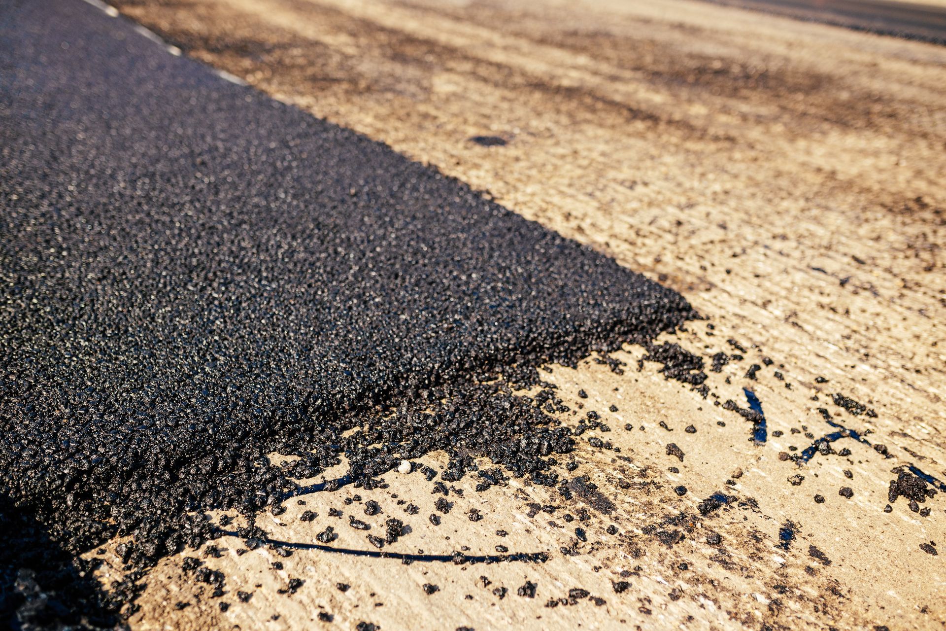 A close up of a piece of asphalt on a dirt road.