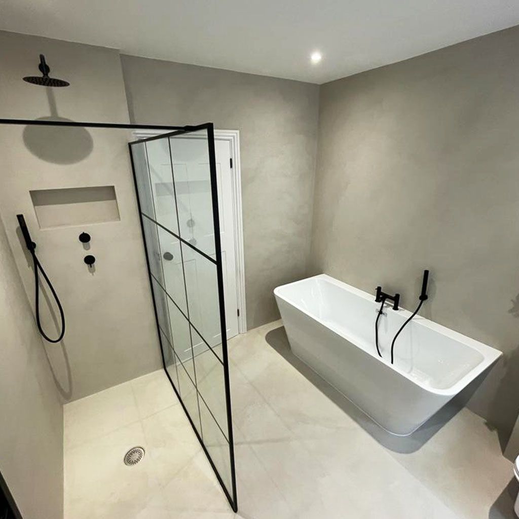 A bathroom with a bathtub and a walk in shower.