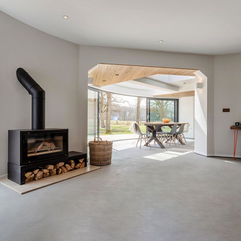 Picture of a microcement floor and a log burner 
