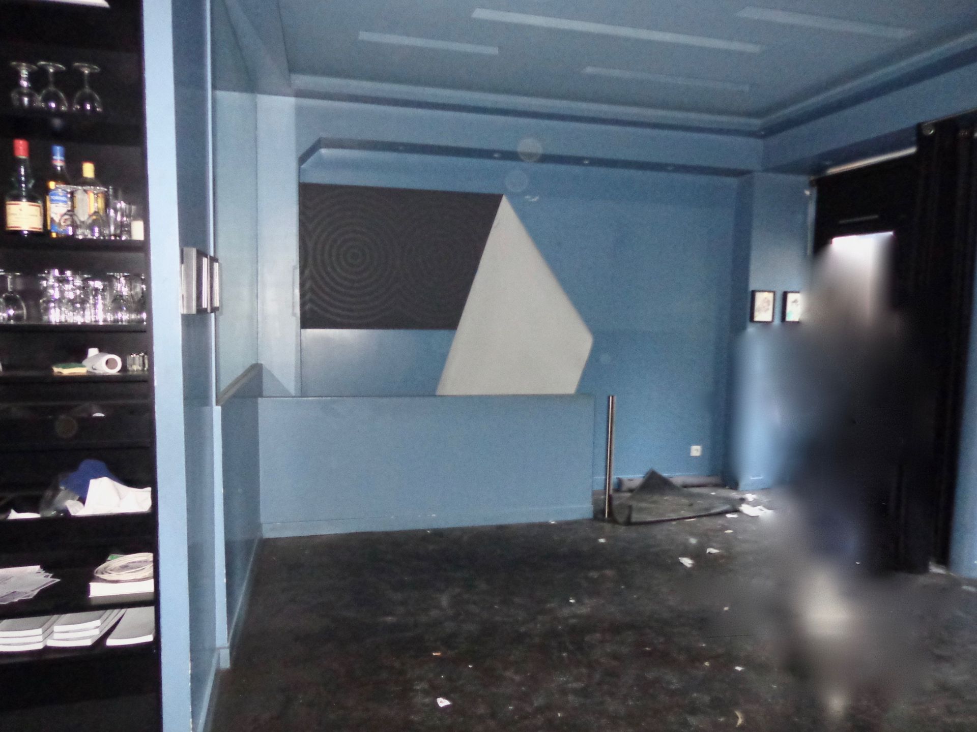 Une pièce vide avec des murs bleus et un sol recouvert de moquette