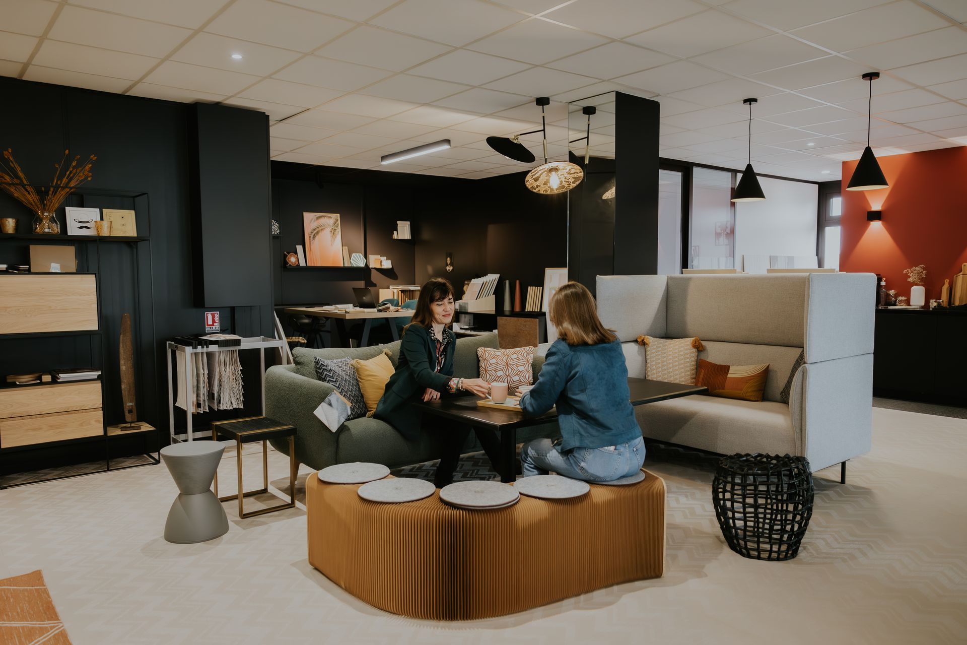 Deux femmes sont assises à une table dans un salon.