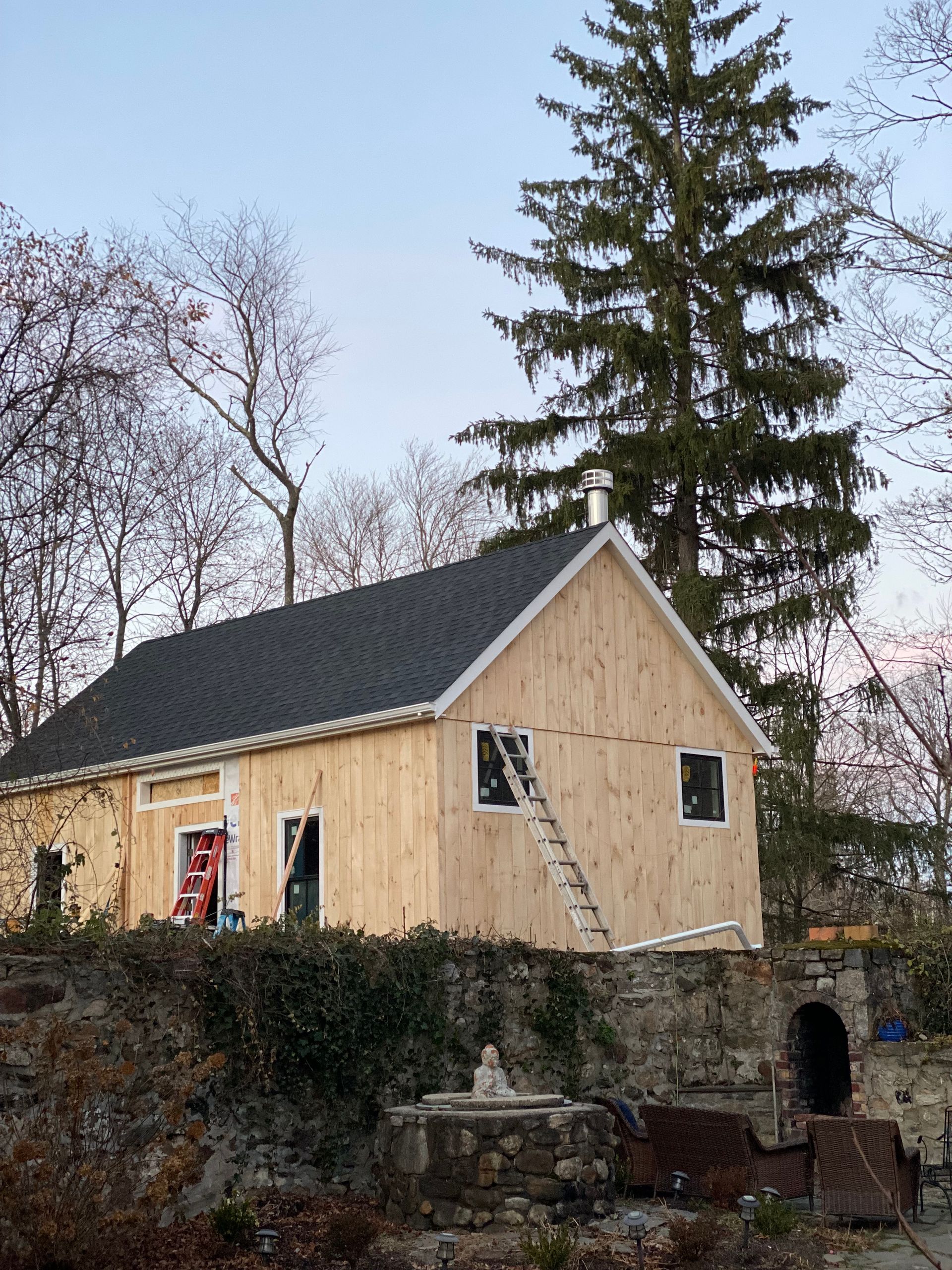 A small wooden house with a ladder on the side of it