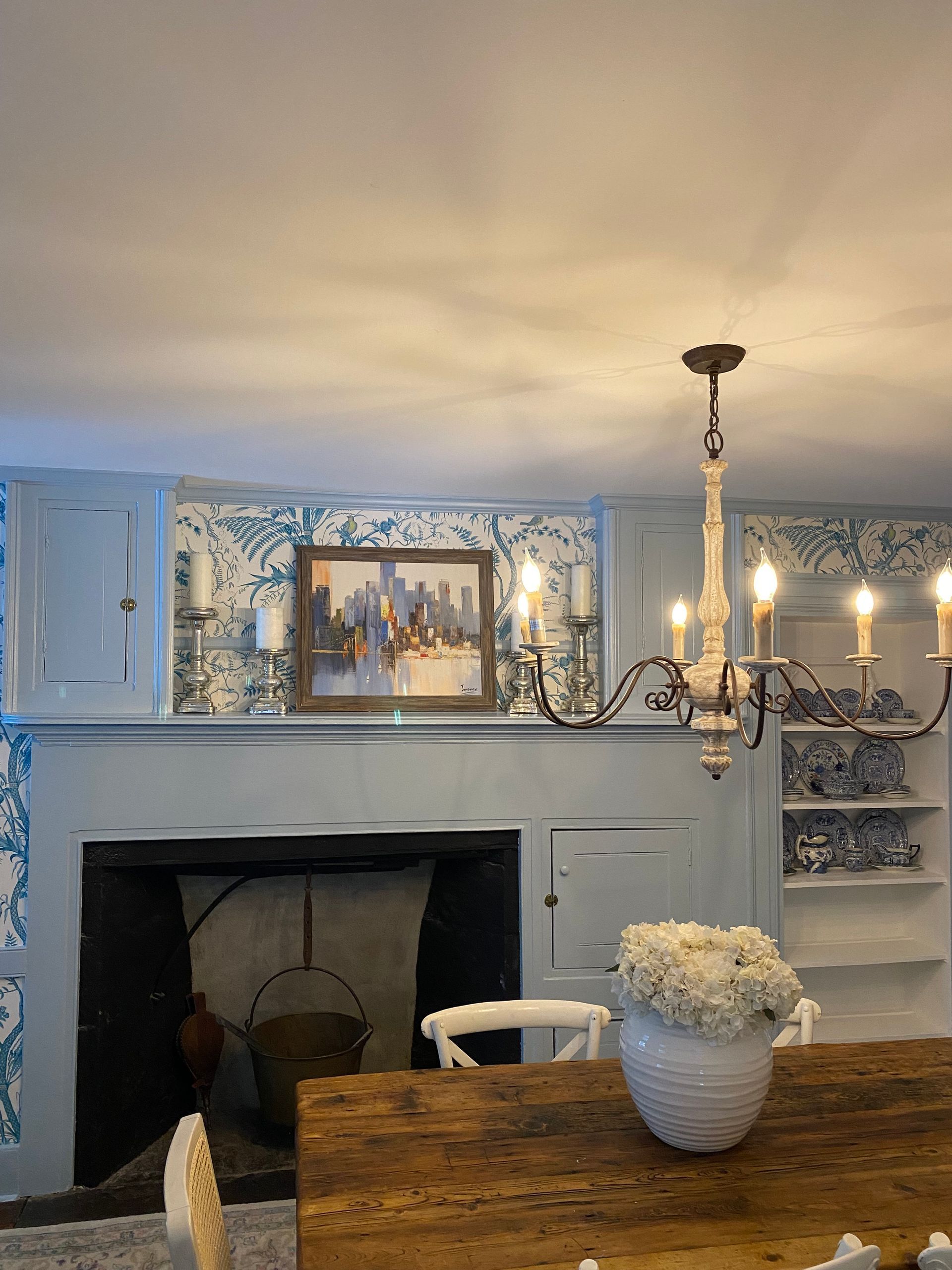 A living room with a fireplace and a chandelier