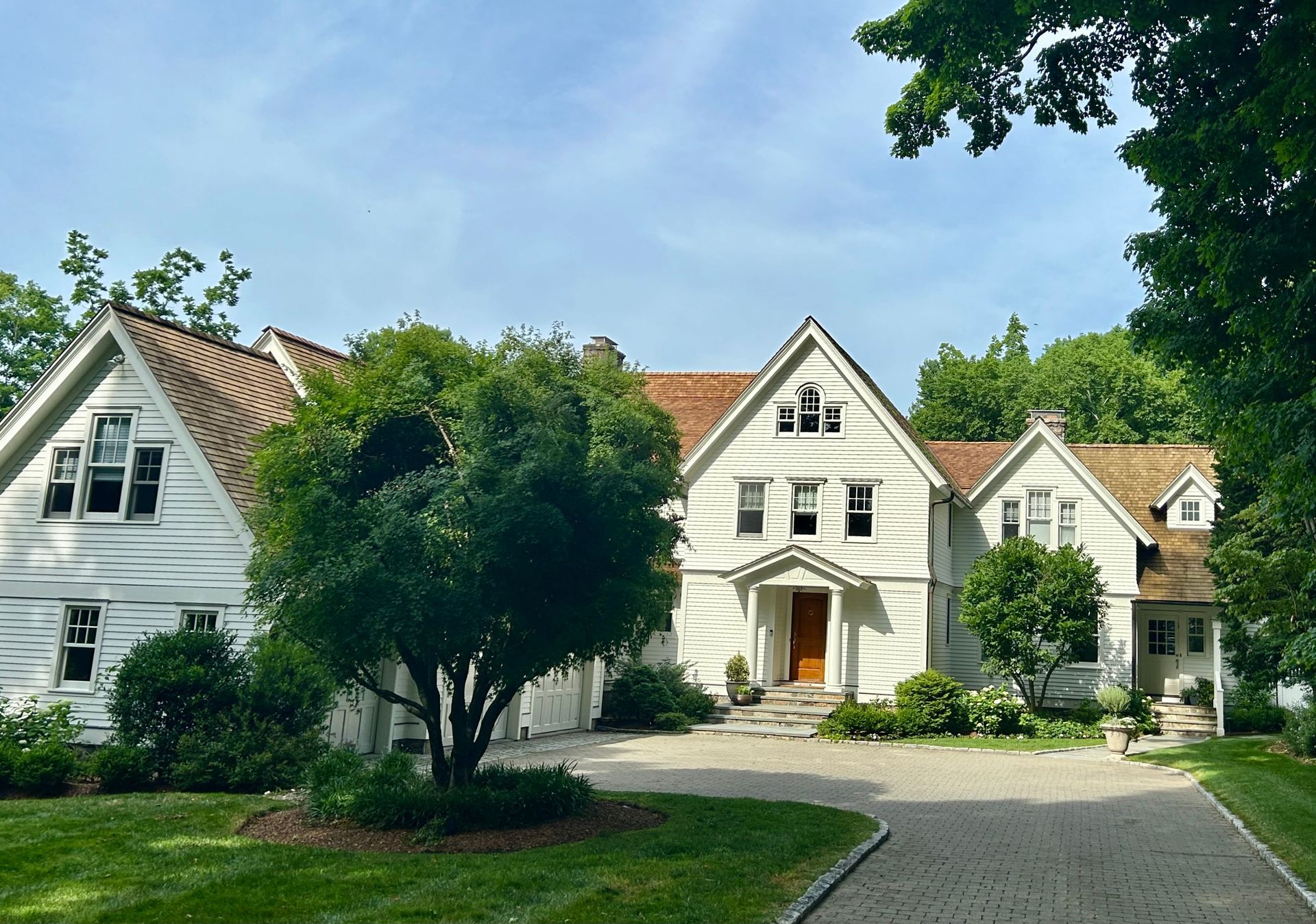 A large white house with a driveway leading to it