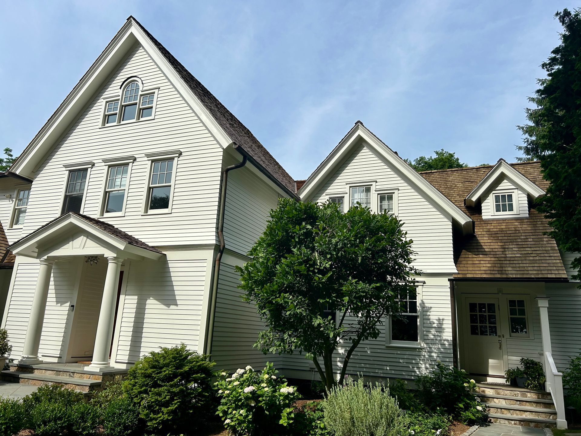 A large white house with a brown roof