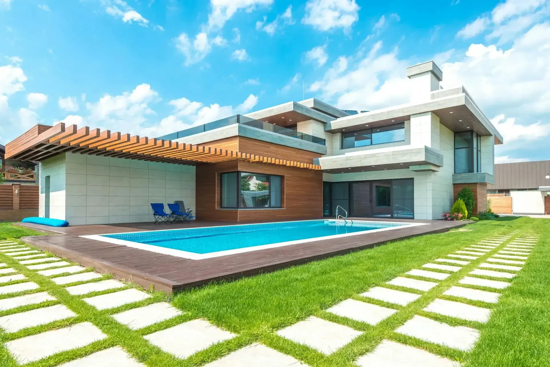 A large modern house with a swimming pool in the backyard.