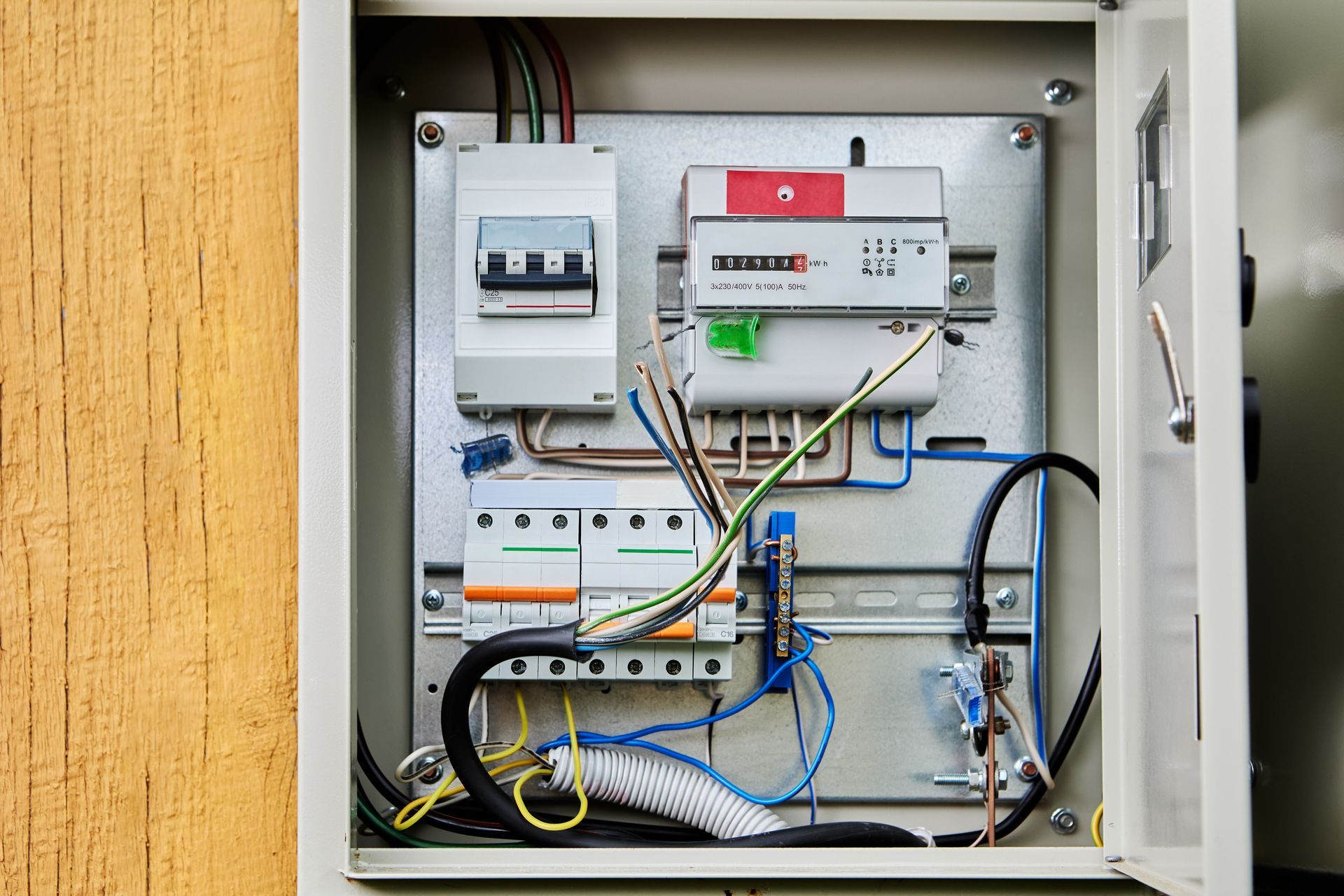 A close up of an electrical box with a lot of wires coming out of it.