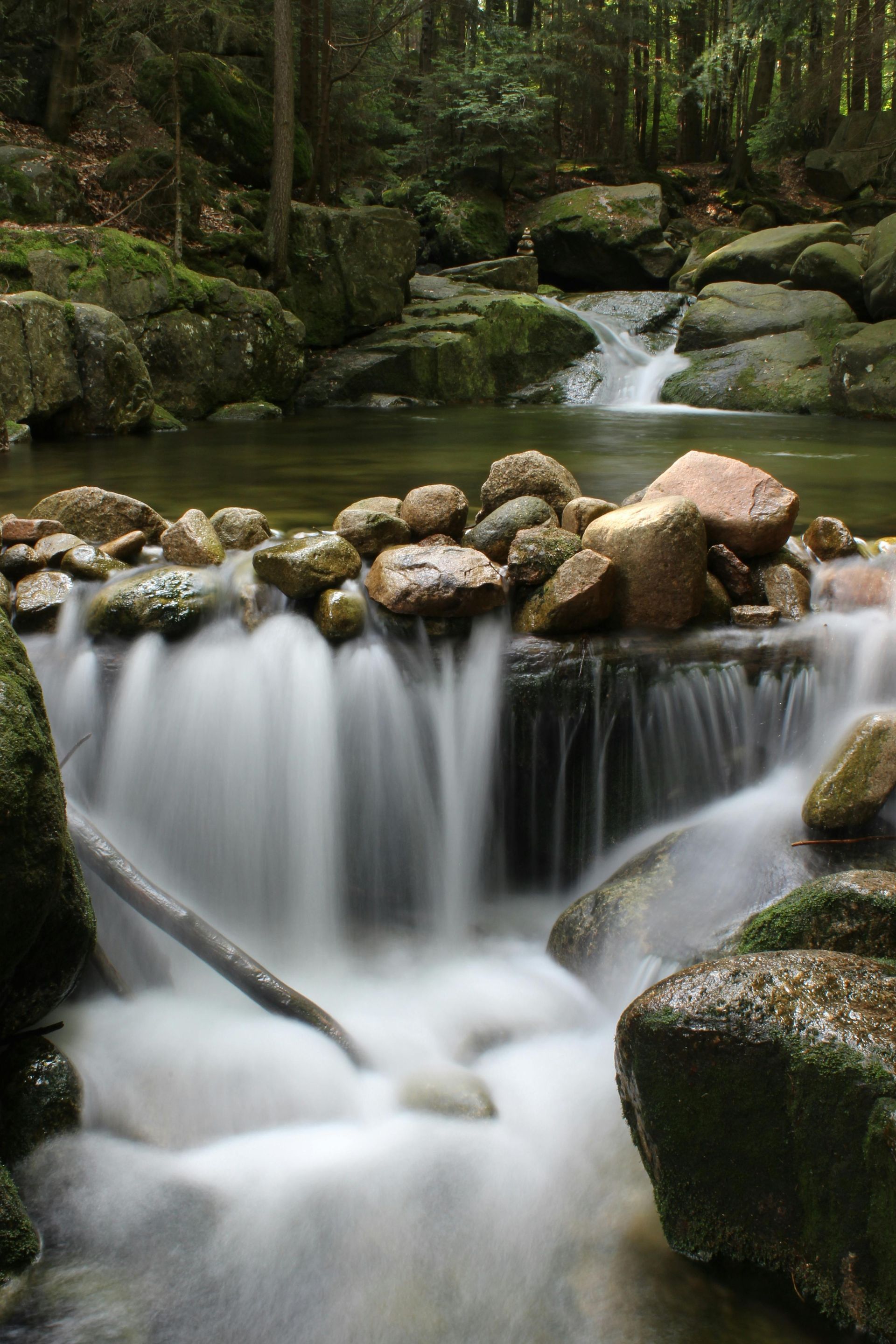 A pile of rocks stacked on top of each other in the water.