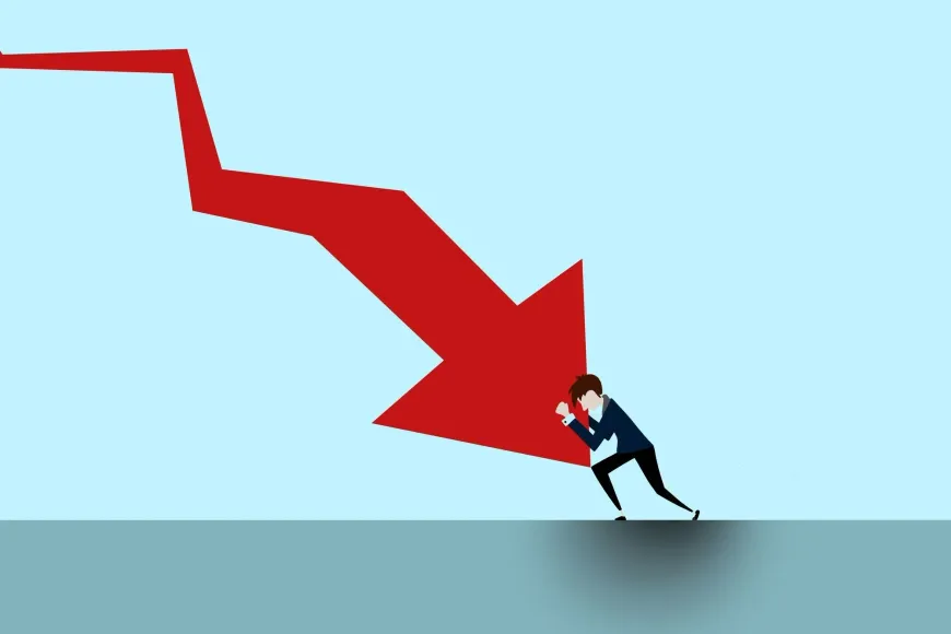 A man is pushing a red arrow down.