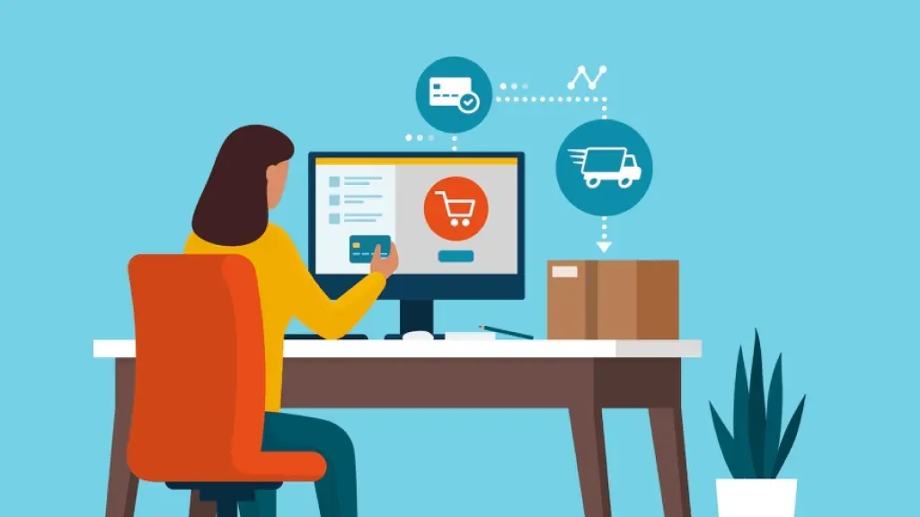 A woman is sitting at a desk using a computer.