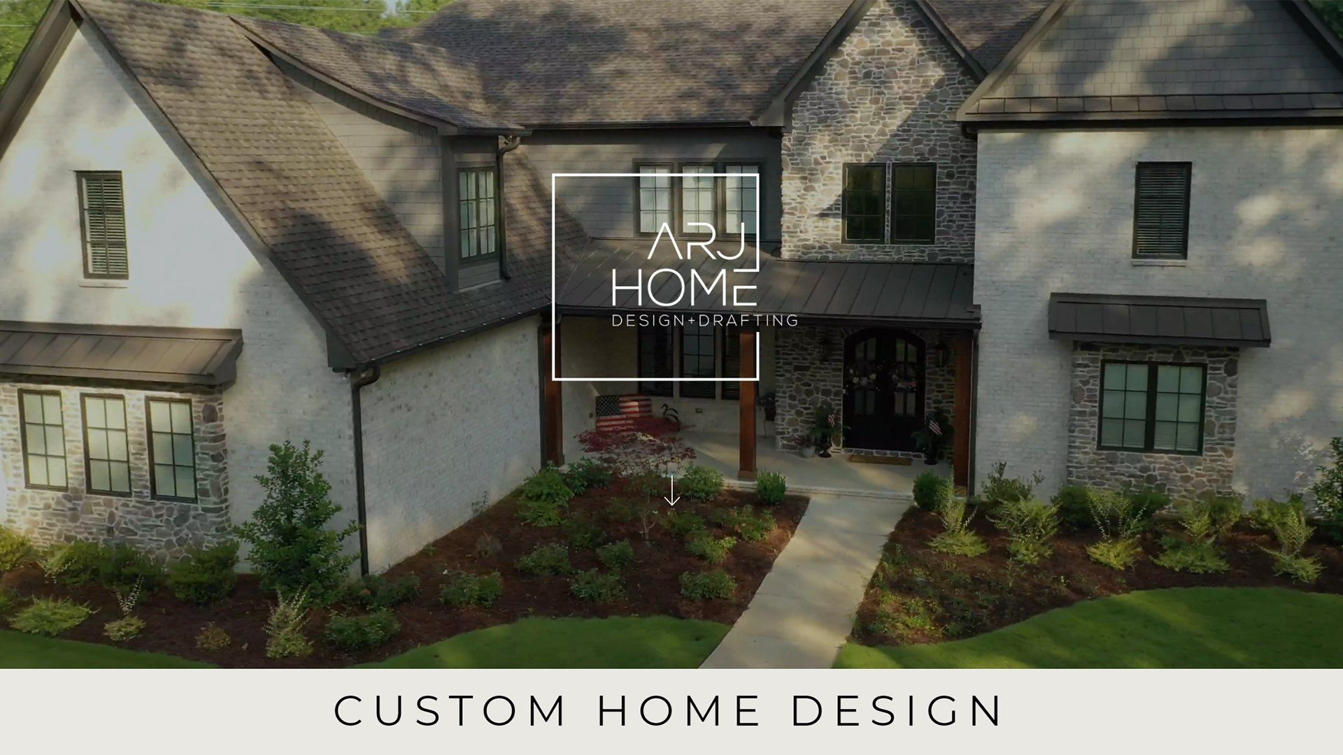 An aerial view of a two-story luxury house with stone and stucco exterior, featuring a white logo and text overlay of a website design for ARJ Home Design by Beyond Technology