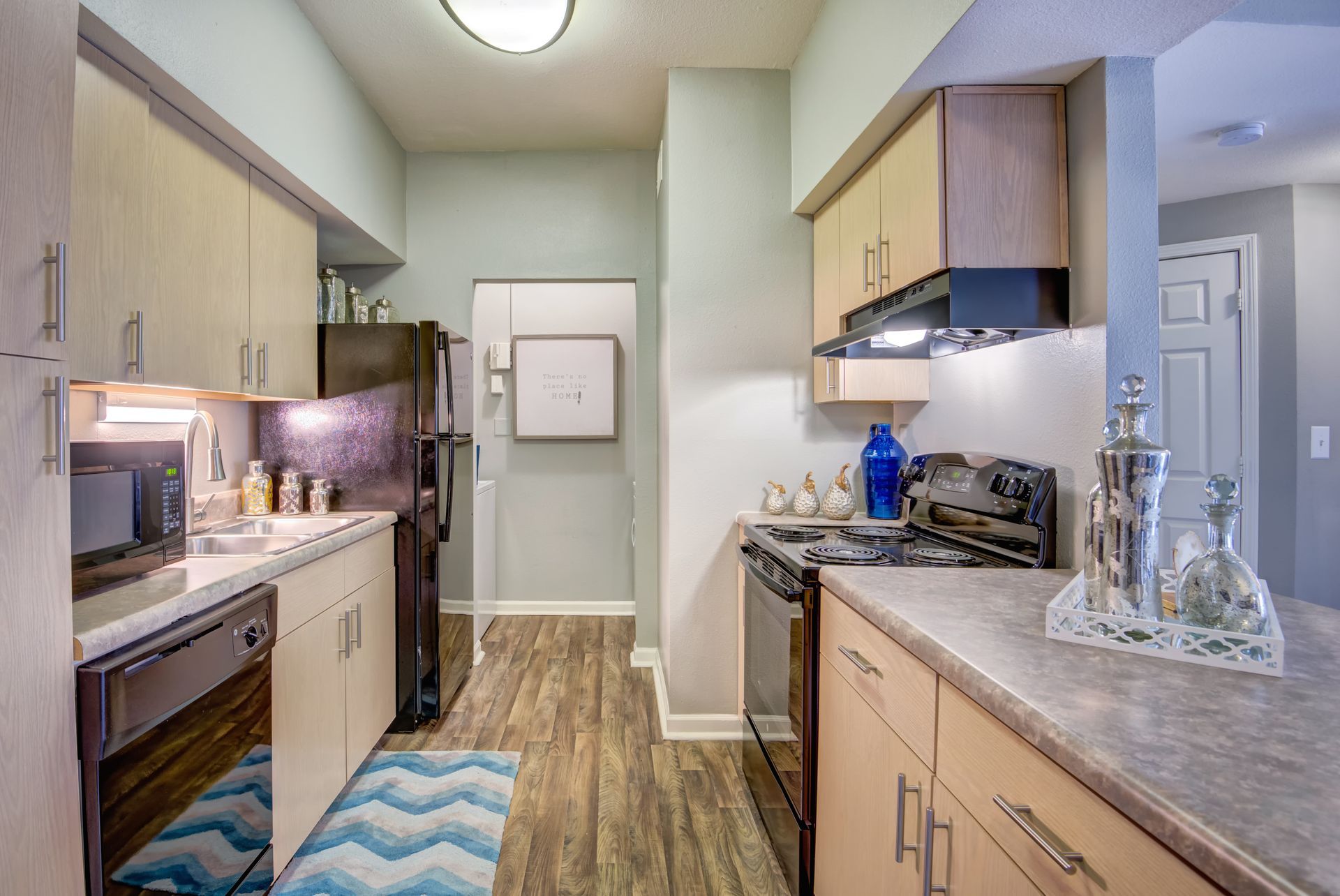 A kitchen with a stove , refrigerator , dishwasher , and microwave.