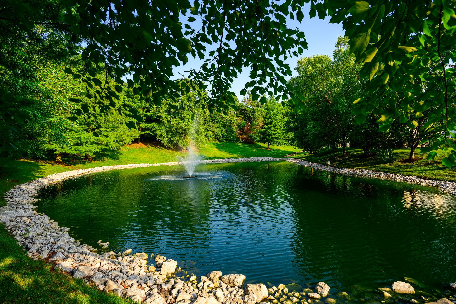 A pond with a fountain in the middle of it