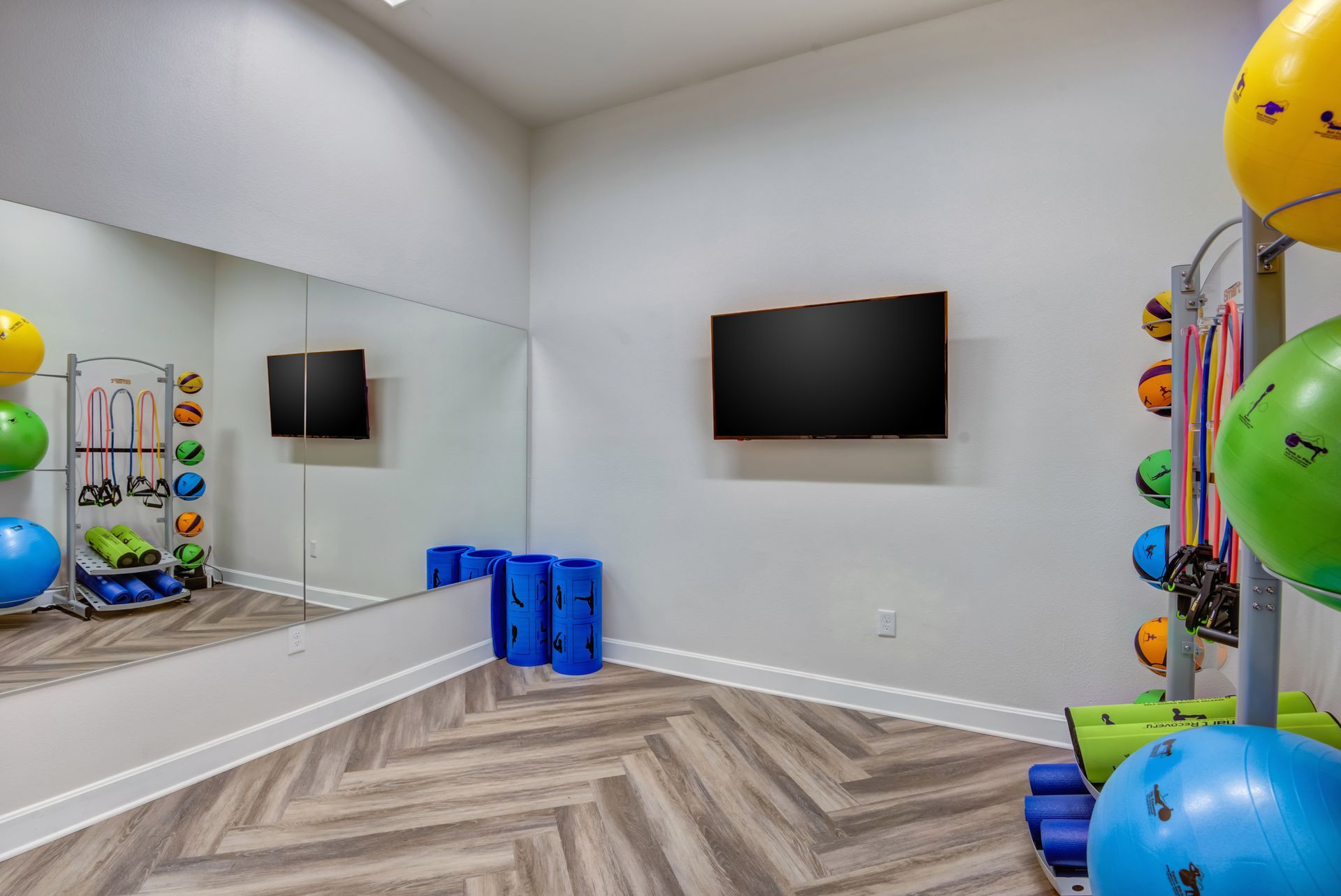 Photo of the community gym with a large mirror on the wall