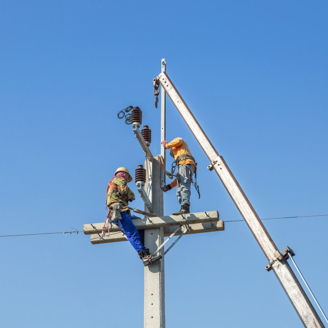 Electricians climbing power pole — R & M Electrical in Townsville, QLD