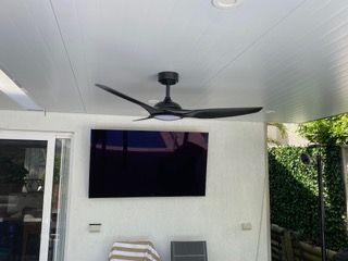 A modern black three-blade ceiling fan with a light — Channel Electrical In Swansea Heads, NSW