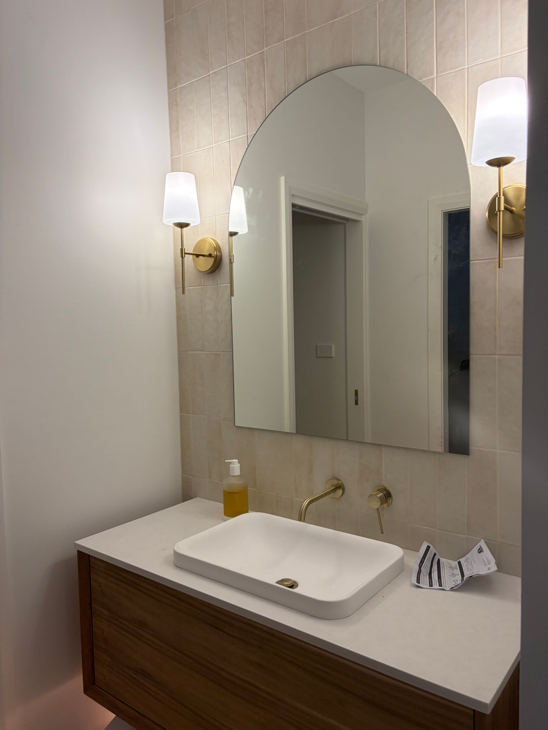 A modern bathroom vanity with a wood cabinet — Channel Electrical In Swansea Heads, NSW
