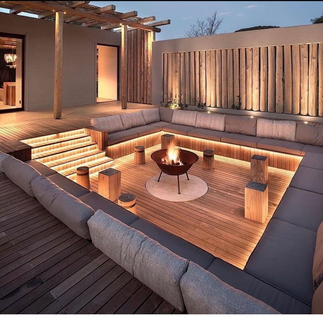 Sunken fire pit lounge with gray modular seating — Channel Electrical In Swansea Heads, NSW