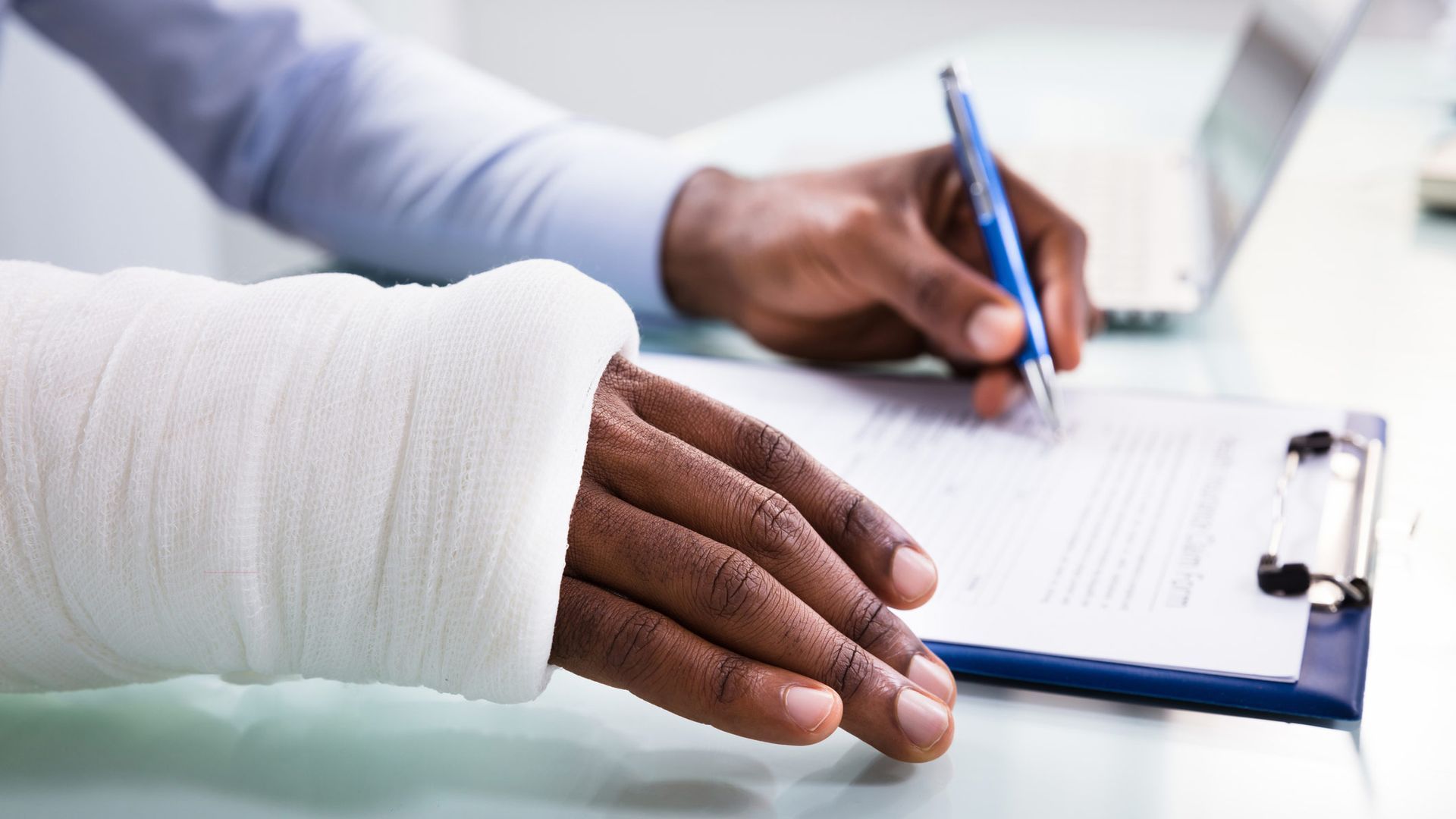 Injured Man With Bandage Hand Filling Form — Portsmouth, VA — Bangel, Bangel & Bangel, L.L.P.
