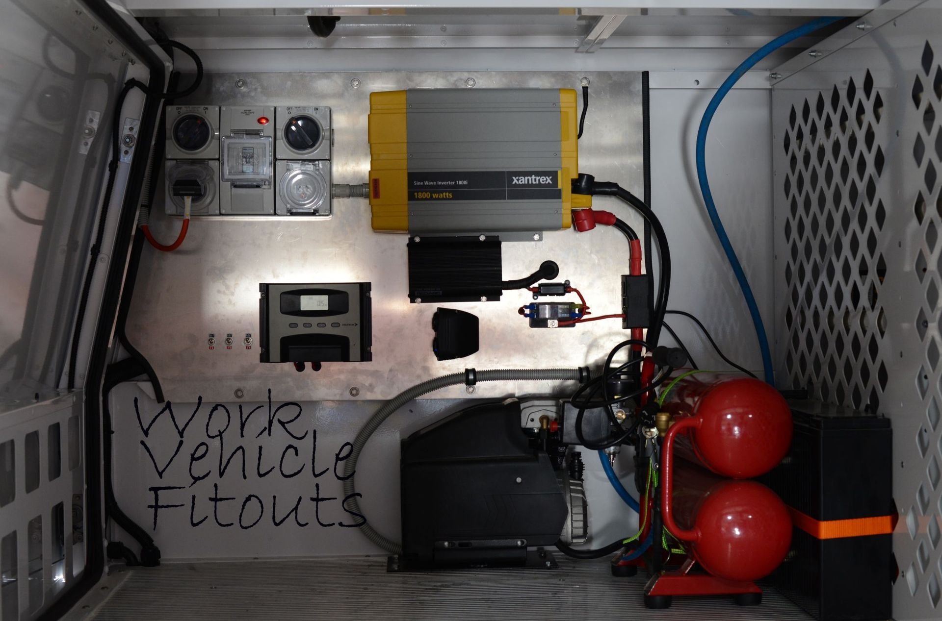 A Man Is Working On The Engine Of A Car In A Garage — Tim Warren Auto Airconditioning & Electrical In Bowen, QLD
