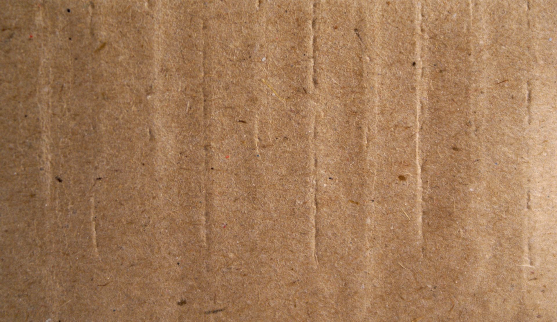 Brown cardboard with vertical ridges.