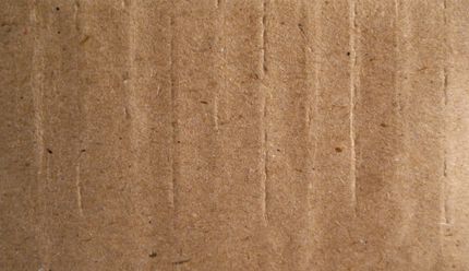 Brown corrugated cardboard, textured with vertical lines.