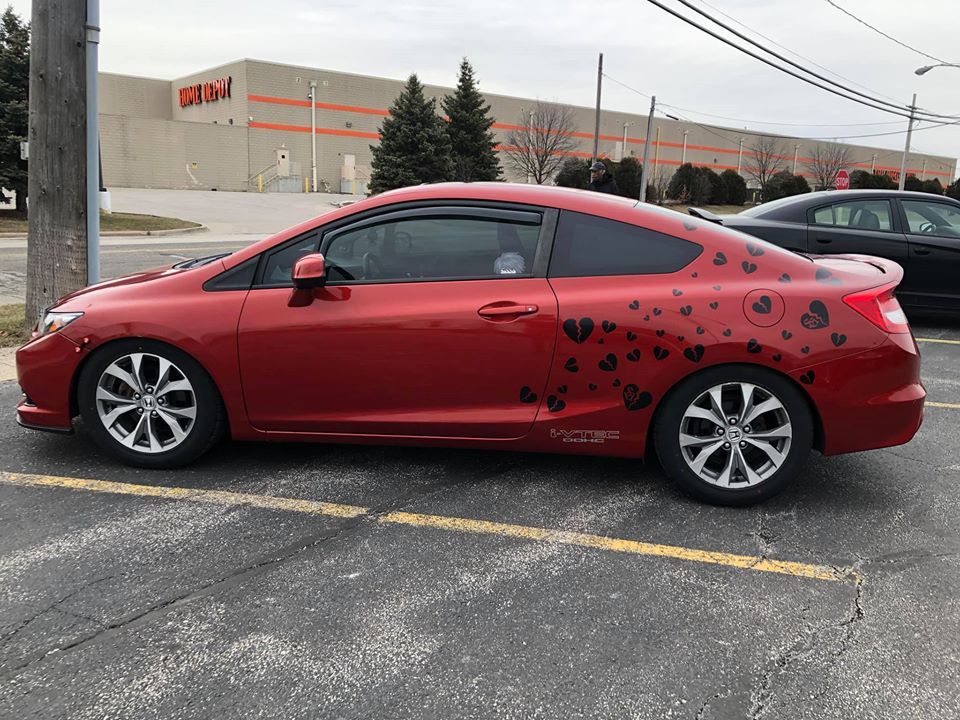 Red Sedan with Stickers — Maple Heights, OH — Winning Window Tints