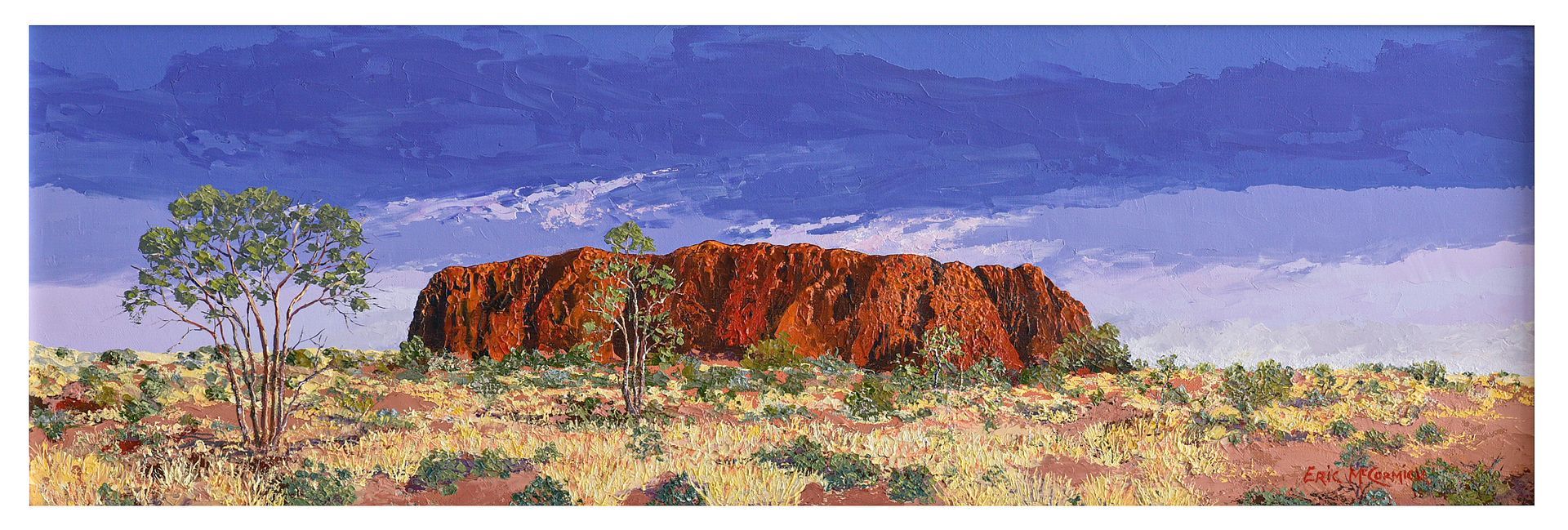 Red rock formation in an arid landscape, a tree on the left, against a blue and cloudy sky.By The artist Eric McCormick