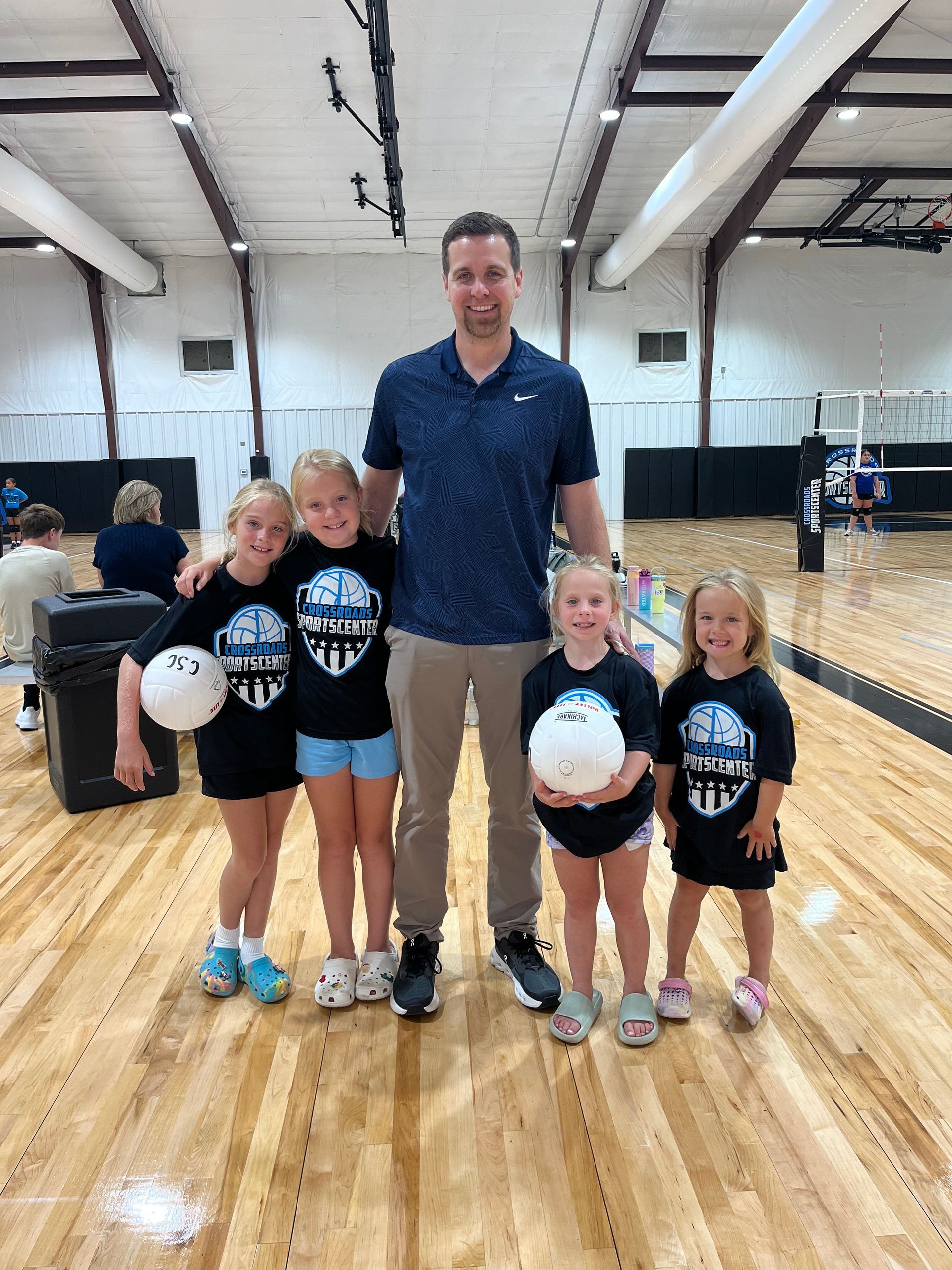 Two young boys are playing basketball on a court.
