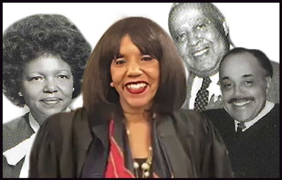 Woman smiling with vintage black and white portraits behind her.