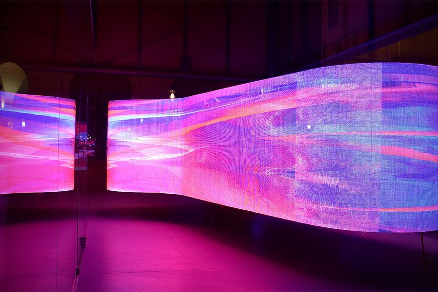 A purple and blue light display is hanging from the ceiling.