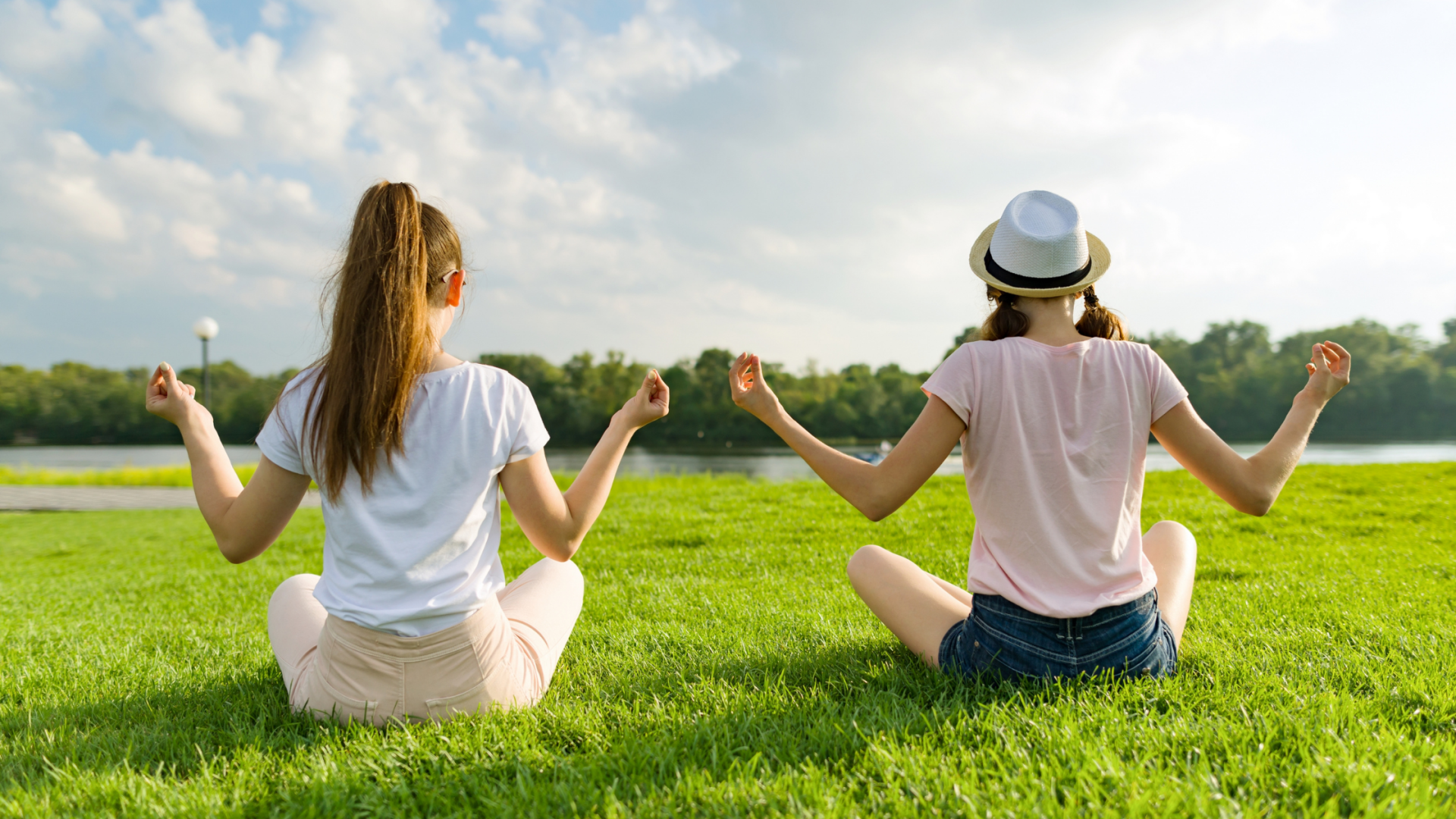 Young adult females practicing meditation together